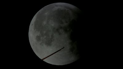 Passenger Jet in front of Moon
